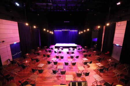 Gezellige setting in Theaterzaal met tafeltjes en stoeltjes